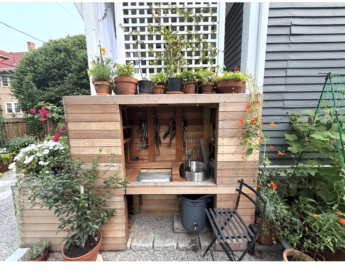 The Thickening Plot's built-in potting bench with sink and tool wall